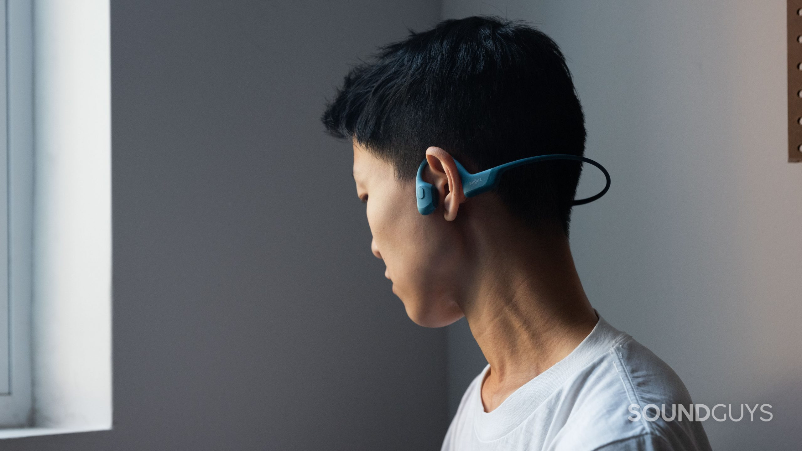 Shokz OpenRun Pro person wears bone conduction headphones A person wears the Shokz OpenRun Pro bone conduction headphones.