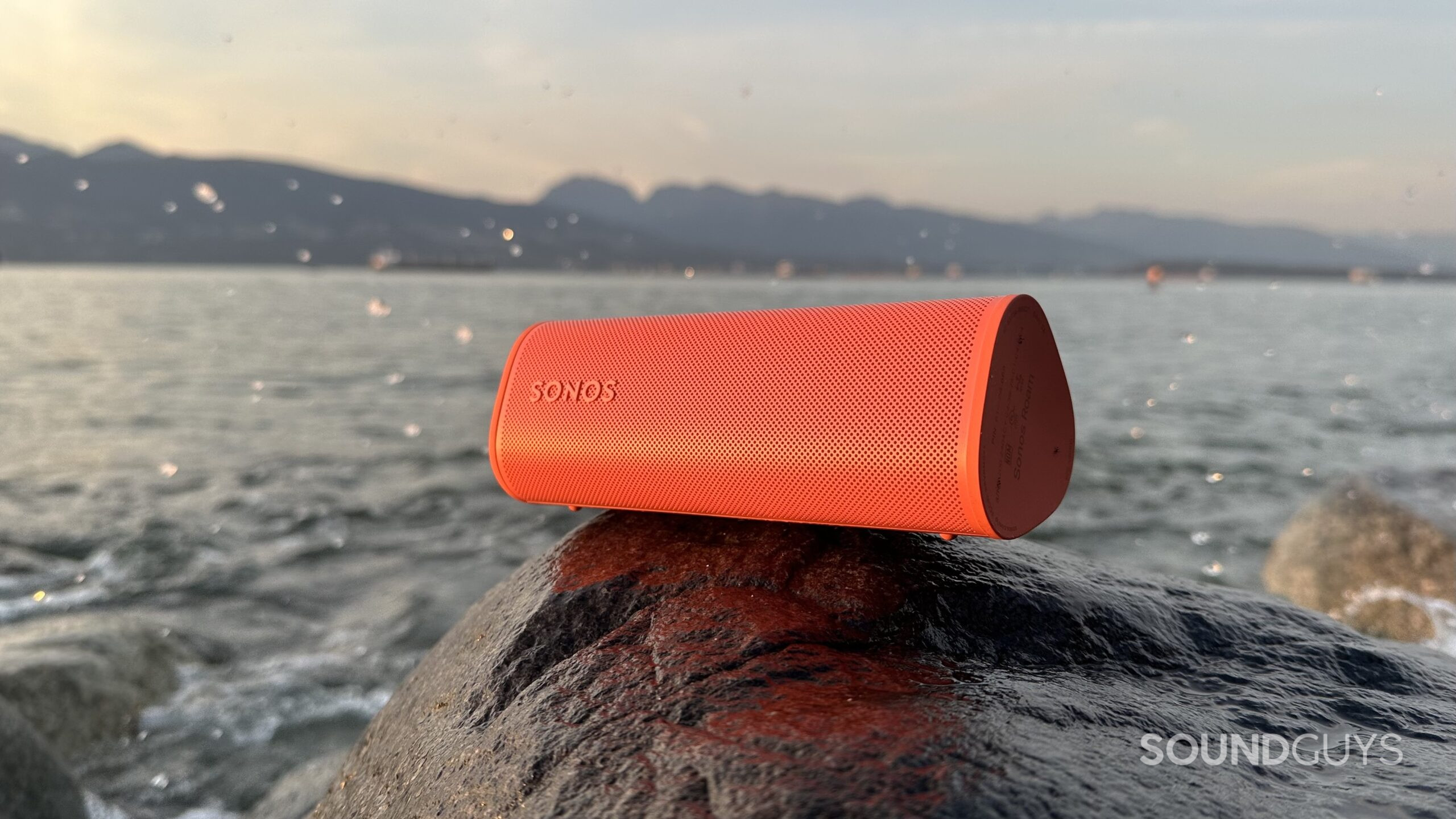 Sonos Roam 2 Hereo alternative Sonos Roam 2 speaker placed on a rock beside the ocean.