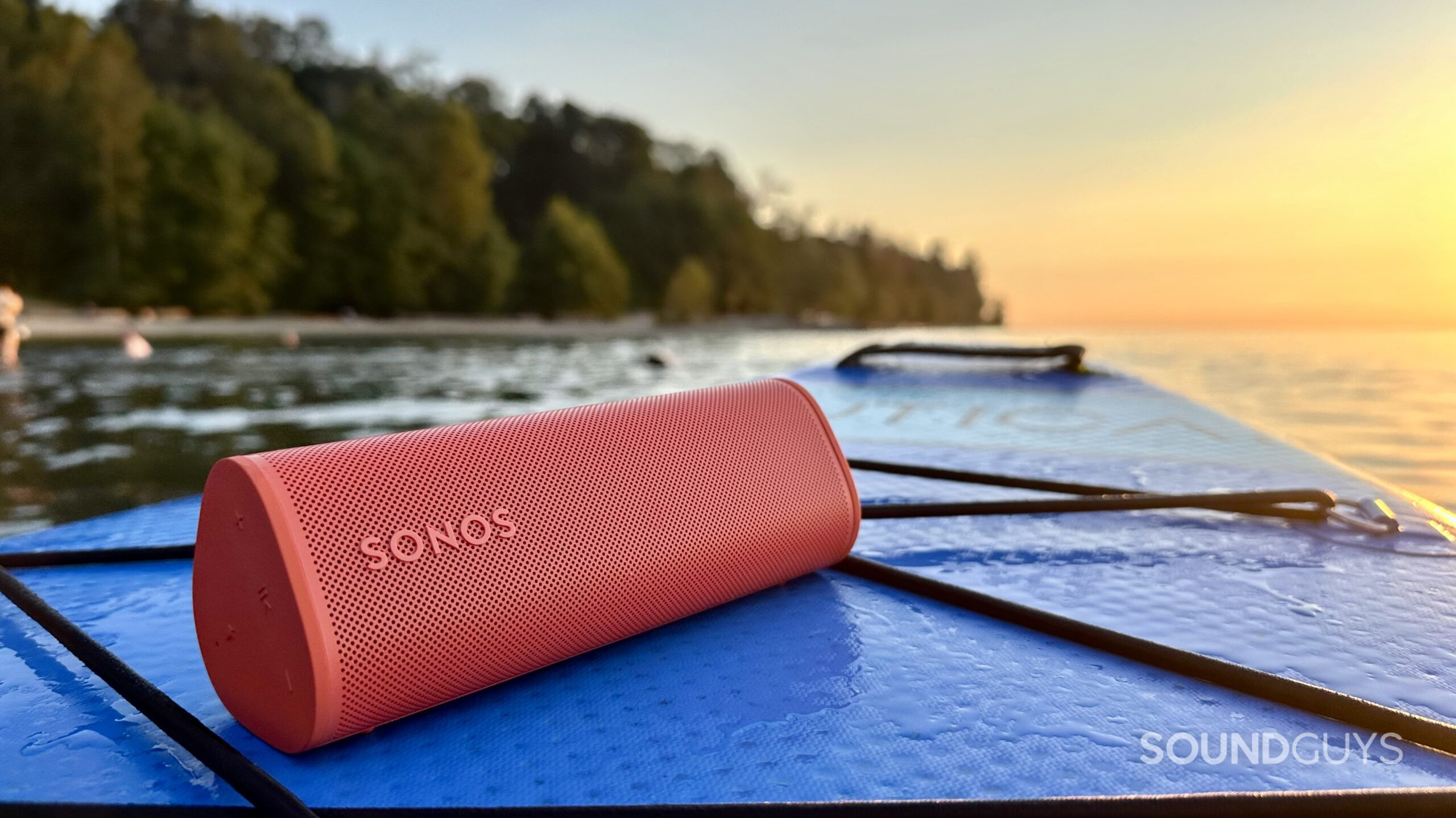 Sonos Roam 2 paddle board Sonos Roam 2 speaker placed on a paddle board looking towards the sunset