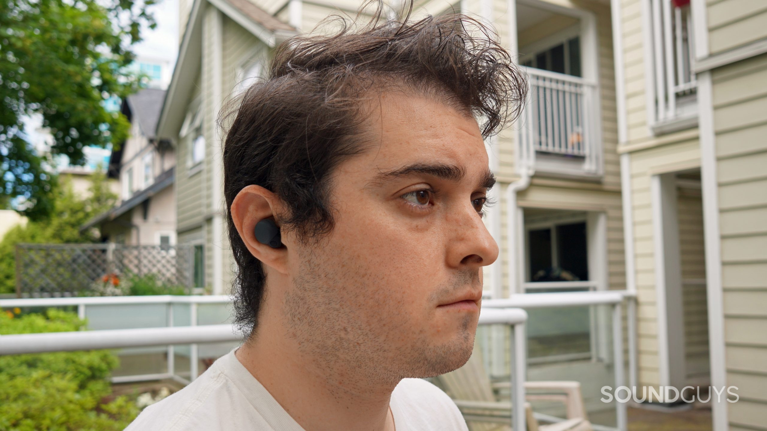 Sony-LinkBuds-S-headshot A man sits outside wearing the Sony LinkBuds S