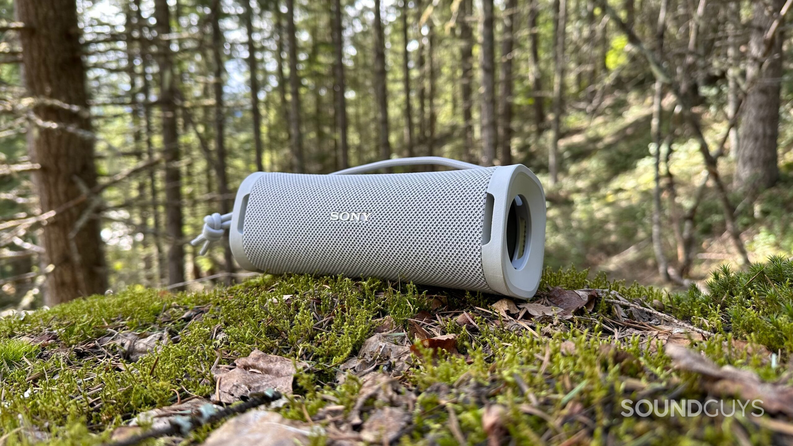 Sony ULT Field 1 5 The Sony ULT Field 1 speaker facing to the left on a mossy mountainside rock.