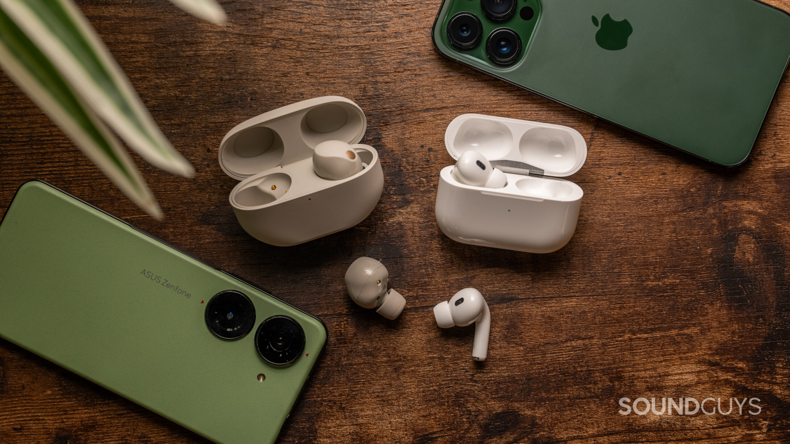 Sony WF-1000XM5 vs Apple AirPods Pro 2nd generation cases earbuds iPhone Asus Zenfone The Sony WF-1000XM5 and Apple AirPods Pro 2 next to each other with one bud out of the case for each.