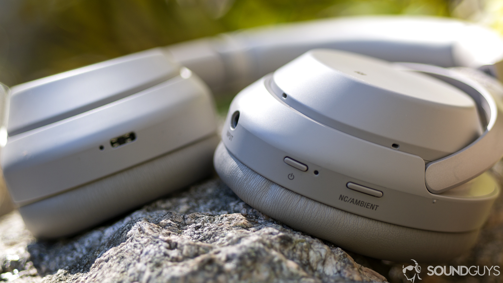 sony-wh-1000x-m3-controls A photo of the Sony WH-1000XM3 sitting on a stone wall, showing the ports and controls.