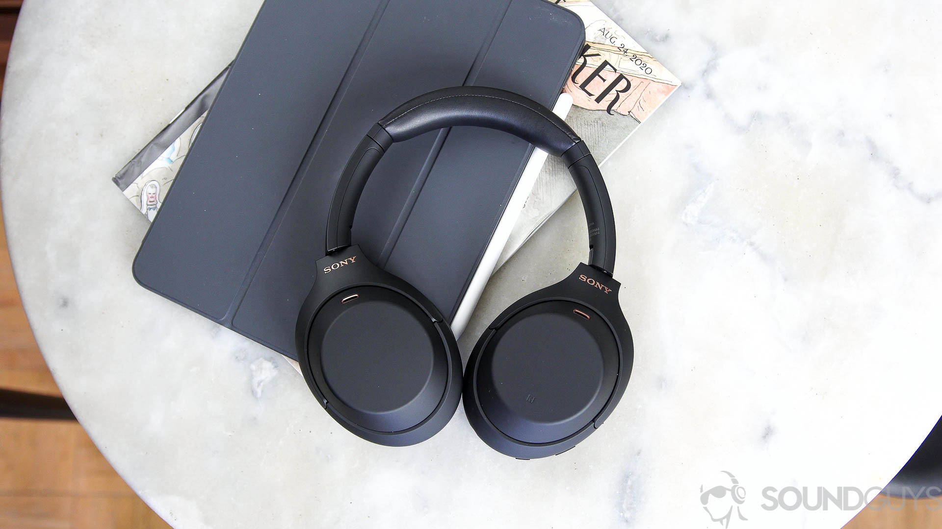 Sony WH-1000XM4 multipoint Sony WH-1000XM4 headphones next to iPad Pro on a marble surface