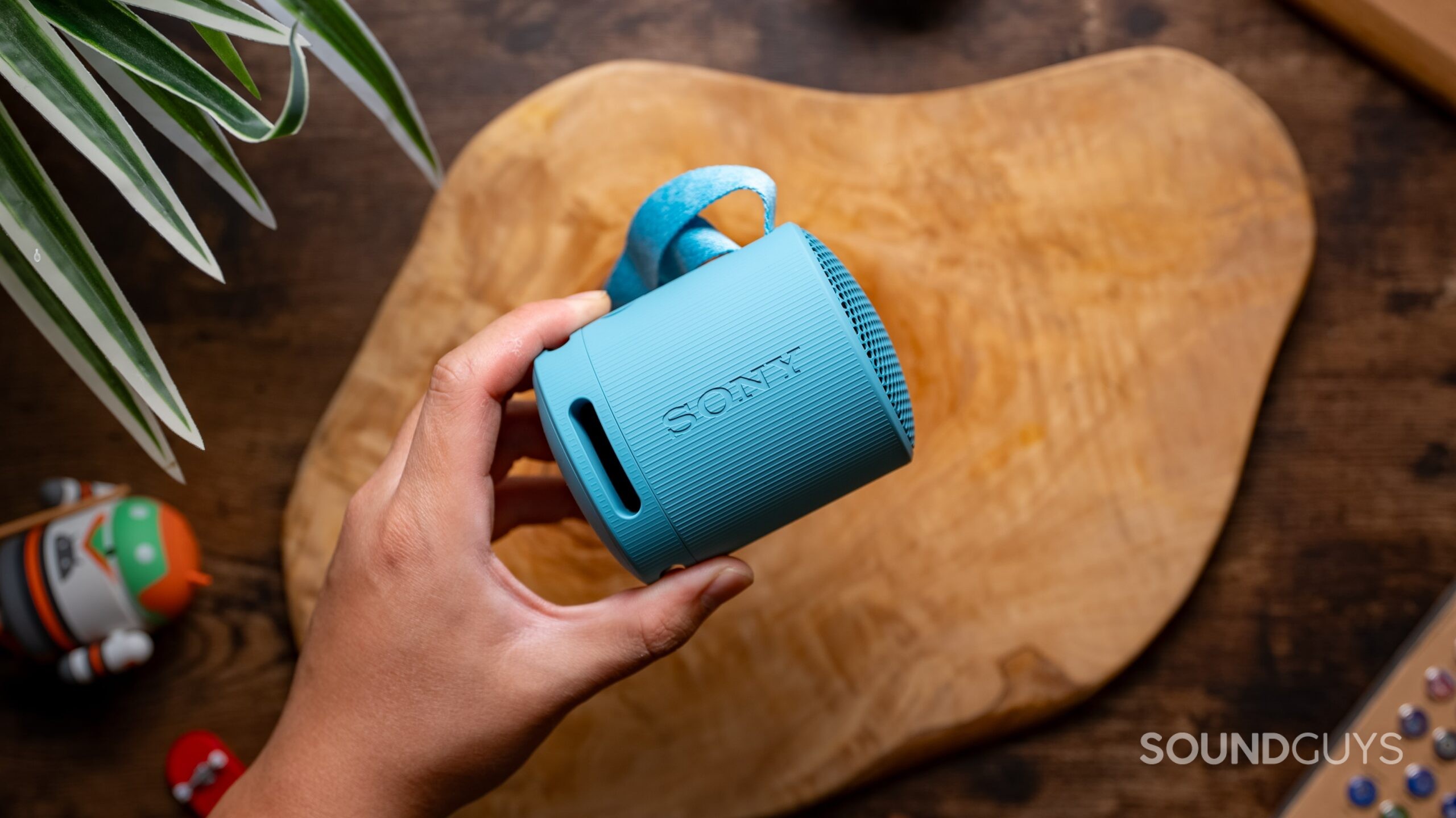 Sony XB100 Wireless Speaker Featured Image #2 A hand holding the Sony SRS-XB100 speaker.