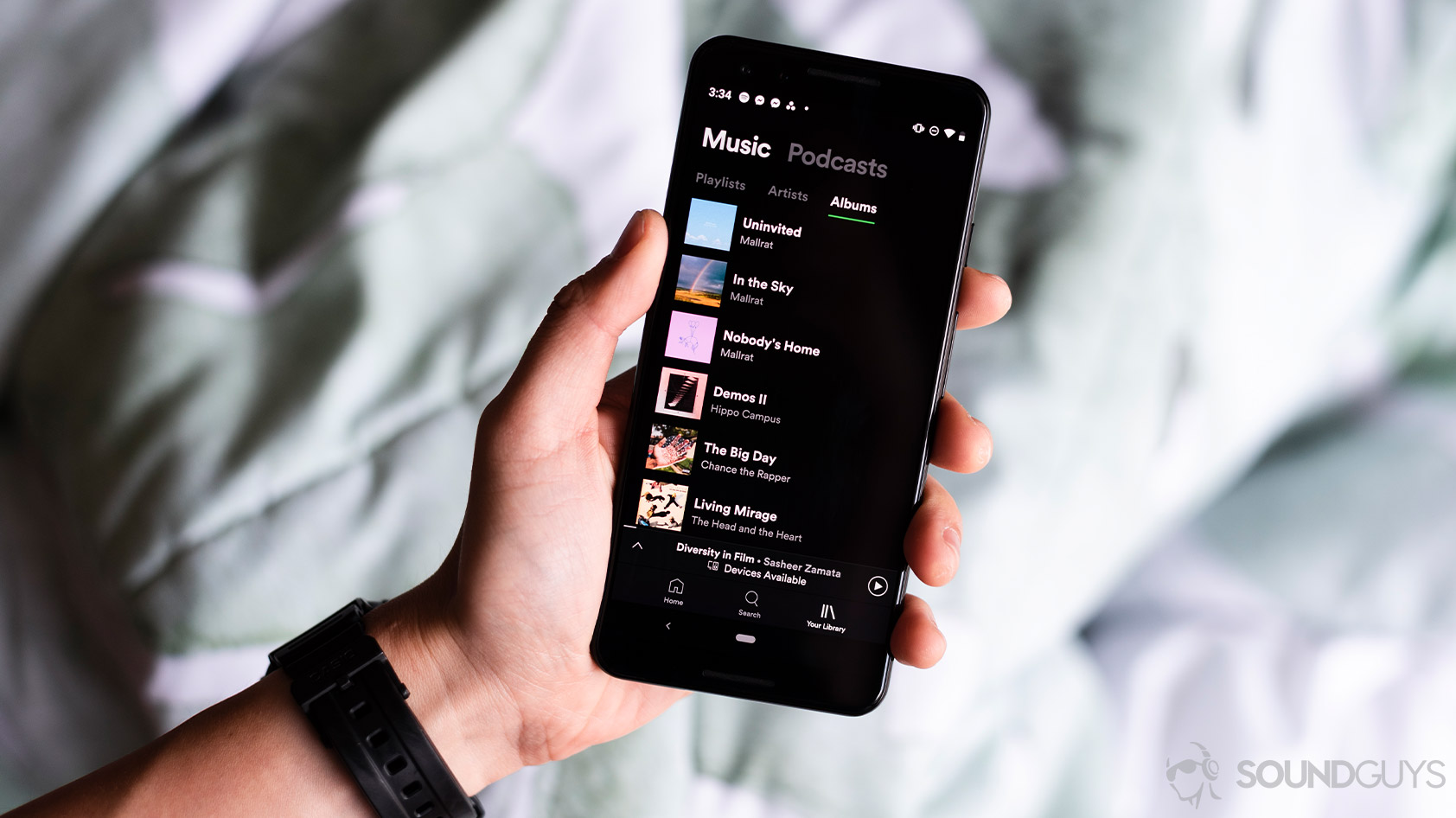 Spotify-2_Google Pixel 3 hand app A woman holds a Google Pixel 3 phone with Spotify open on it.