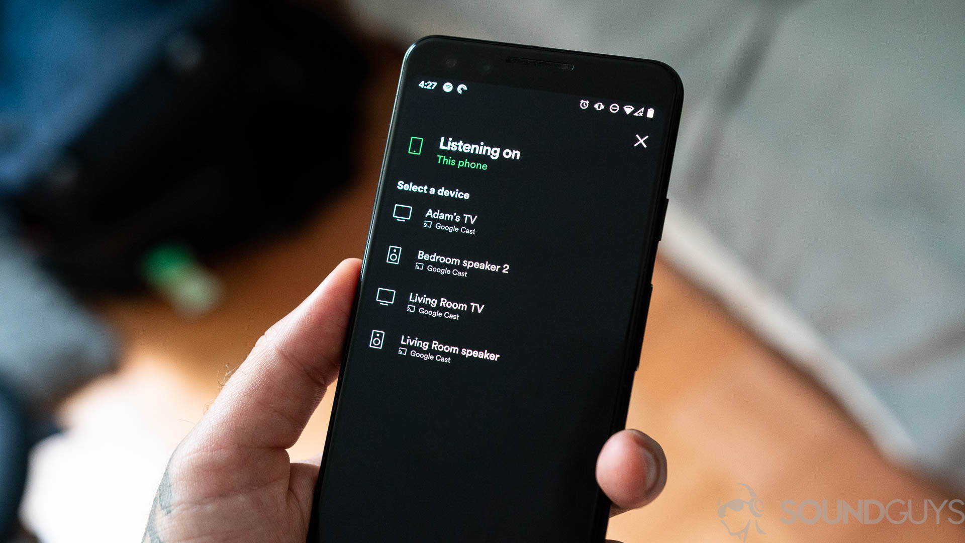 Spotify Connect Shot of man holding Spotify with available devices listed to play music from