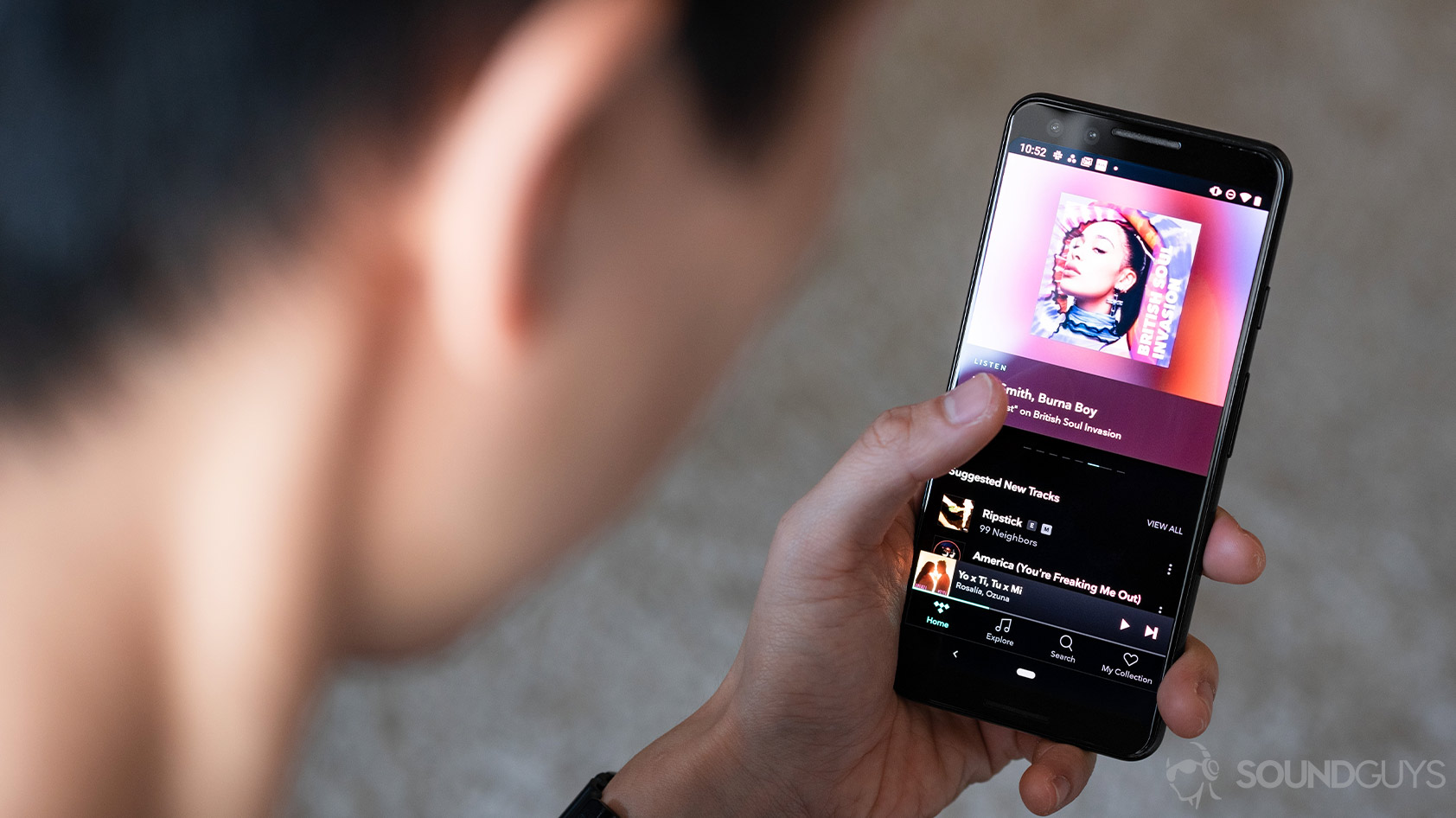 Tidal-5_mobile app Google Pixel 3 woman holding A woman holding a Google Pixel 3 with the Tidal HiFi app pulled up.