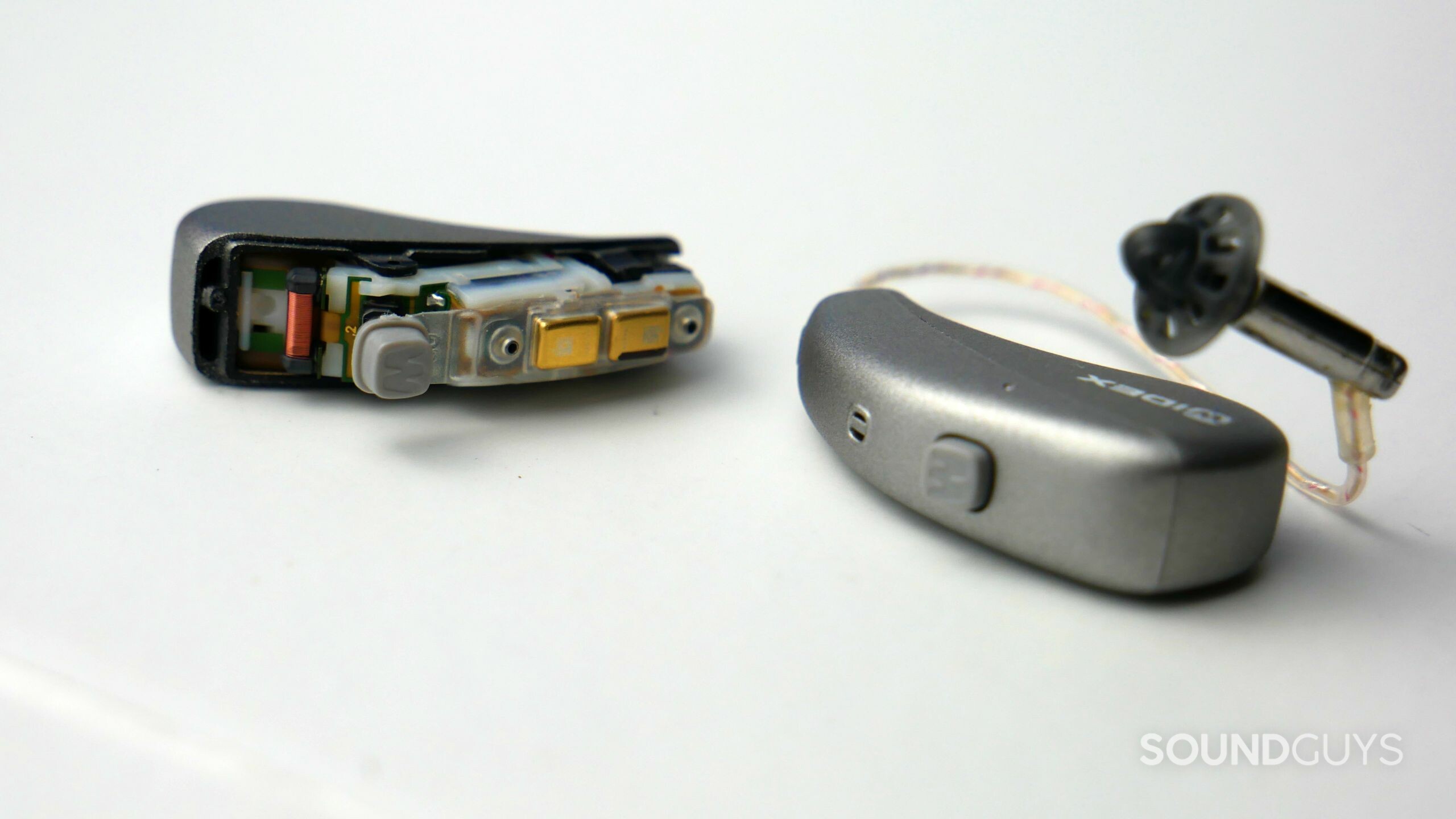 Widex MOMENT Telecoil A pair of Widex MOMENT hearing aids with the left one disassembled to expose its telecoil.